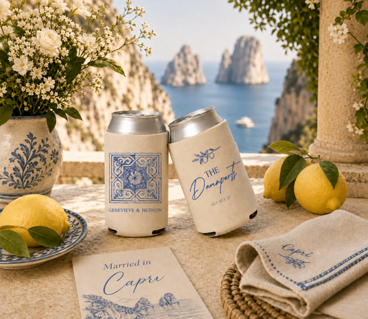 Personalized Amalfi Coast wedding can coolers with custom names, blue tile artwork, and cream drink sleeves