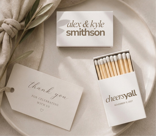 Personalized Cheers Yβall wedding matchboxes with custom names, wedding date, and black typography on white matchboxes