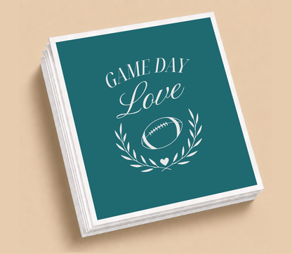 Personalized Game Day Love football wedding napkins featuring a football, laurel wreath, heart detail, and elegant white lettering on teal.