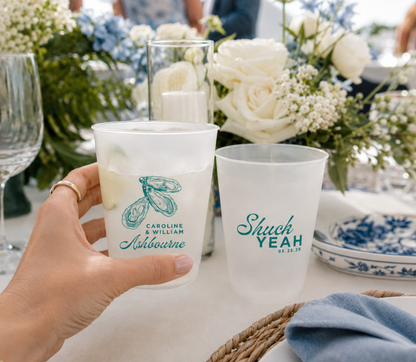 Personalized oyster wedding frosted cups featuring coastal oyster artwork couple names and wedding date
