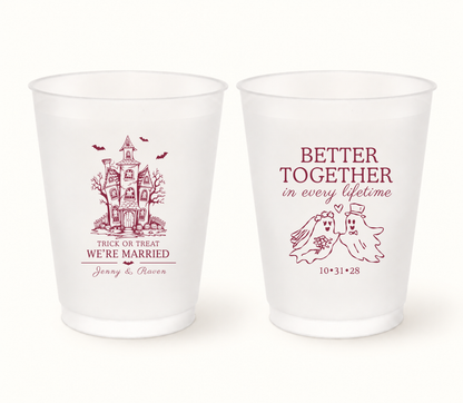 Personalized Better Together Halloween wedding frosted cups featuring haunted house artwork, ghost bride and groom, custom couple names, wedding date, and Trick or Treat We’re Married design.
