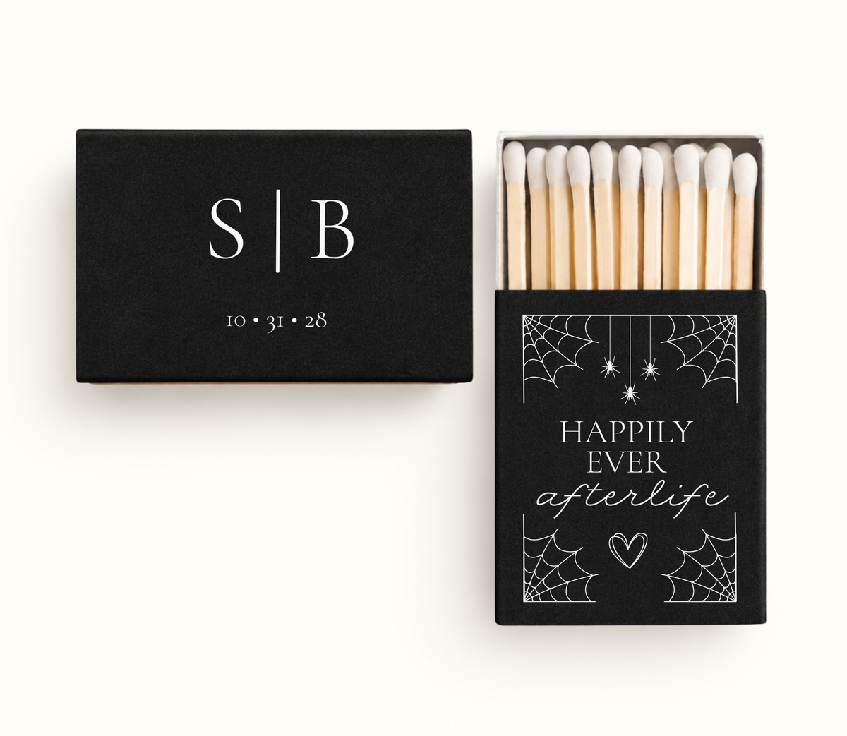 Personalized black Happily Ever Afterlife wedding matchboxes featuring white spiderwebs, hanging spiders, heart artwork, S and B initials, and wedding date 10.31.28.