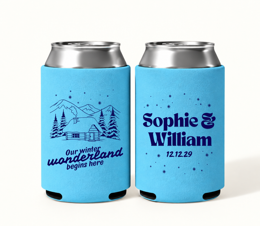 Personalized blue Winter Wonderland wedding can coolers featuring navy mountain cabin and pine tree artwork with Sophie and William names and wedding date.