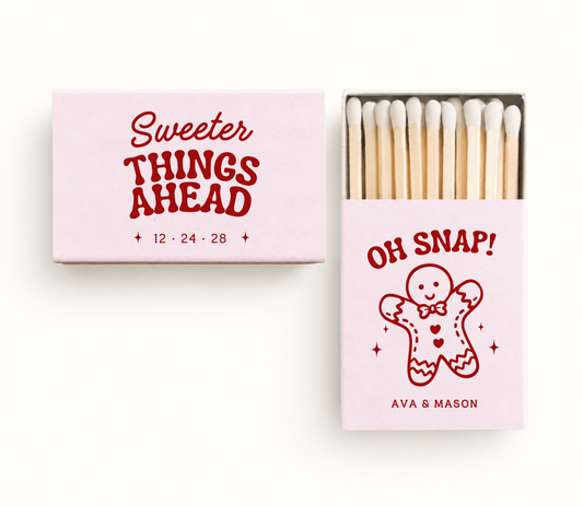 Personalized blush pink gingerbread Christmas wedding matchboxes featuring red gingerbread artwork, Sweeter Things Ahead wording, couple names, and wedding date.