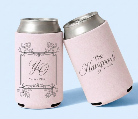 Personalized blush pink wedding can coolers featuring a vintage floral frame with YO monogram and Yanis and Olivia names alongside The Hawgoods family name and wedding date.