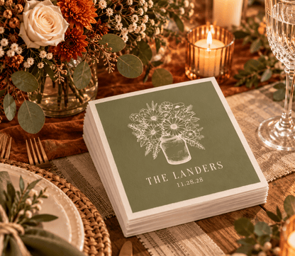 Olive green Thanksgiving wedding napkins featuring a detailed wildflower bouquet in a mason jar and custom family name.