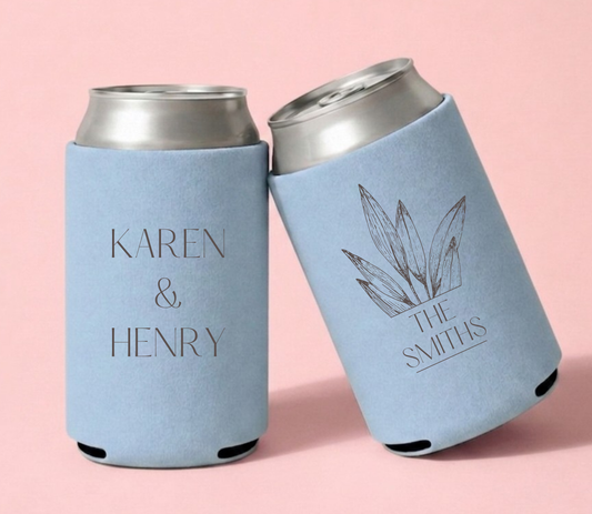 Personalized powder blue wedding can coolers featuring Karen and Henry with a botanical leaf illustration and The Smiths family name in brown ink.