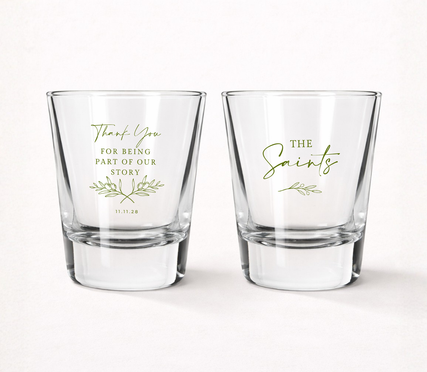 Personalized Thank You wedding shot glasses featuring a custom family name, wedding date, botanical olive branch artwork, and Thank You For Being Part Of Our Story message.