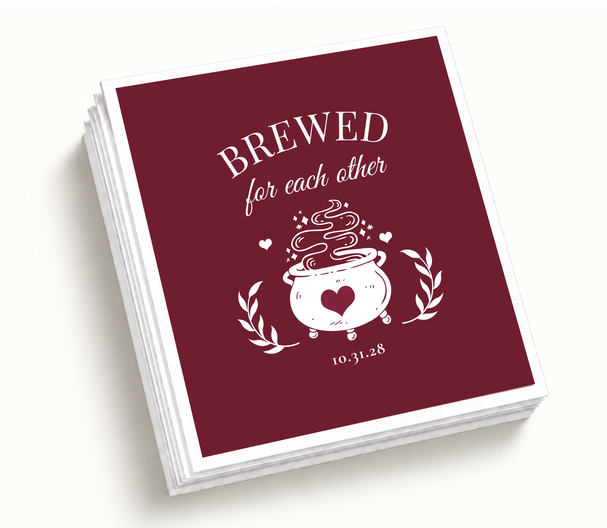 Personalized Brewed for Each Other burgundy Halloween wedding cocktail napkins featuring a bubbling cauldron with heart artwork, botanical accents, and custom wedding date.