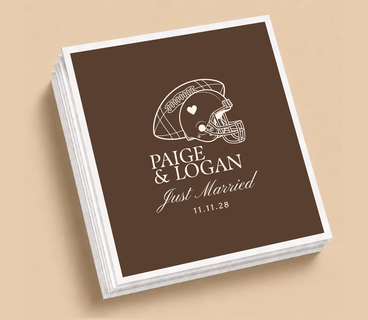 Personalized Just Married football wedding napkins featuring a football helmet with heart detail, Paige and Logan names, and wedding date on a brown background.