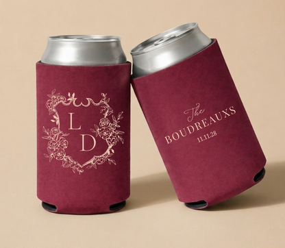Burgundy personalized wedding can coolers featuring a floral crest monogram with initials LD, family name Boudreaux, and wedding date.
