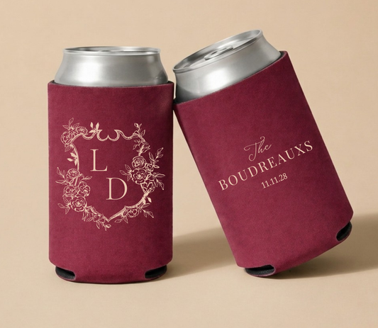 Burgundy personalized wedding can coolers featuring a floral crest monogram with initials LD, family name Boudreaux, and wedding date.
