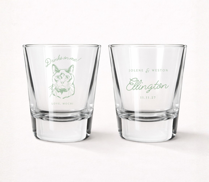 Clear personalized wedding shot glasses featuring a custom cat portrait illustration, pet name, couple names, family surname, and wedding date.