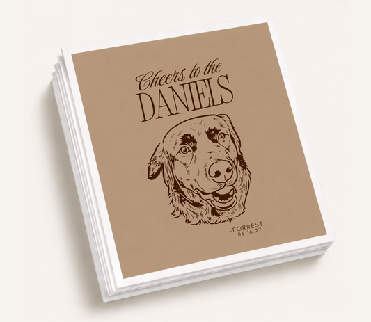 Personalized wedding cocktail napkins featuring a custom illustrated dog portrait, "Cheers to the Daniels" text, pet name, and wedding date for pet-friendly wedding celebrations.