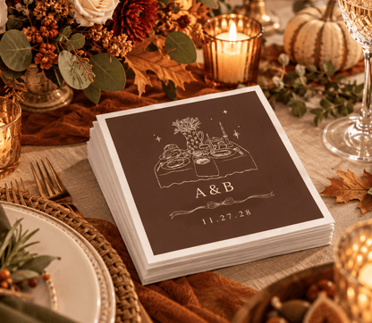 Personalized Thanksgiving wedding napkins with an elegant holiday dinner table illustration and custom couple initials.