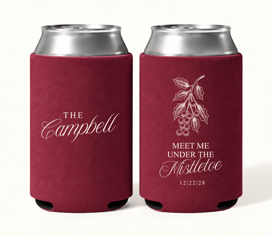 Personalized Meet Me Under the Mistletoe wedding can coolers with vintage holiday artwork, custom surname, and wedding date for Christmas celebrations.

