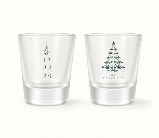 Personalized Christmas wedding shot glasses featuring a Christmas ornament, wedding date, Christmas tree illustration, and family name.