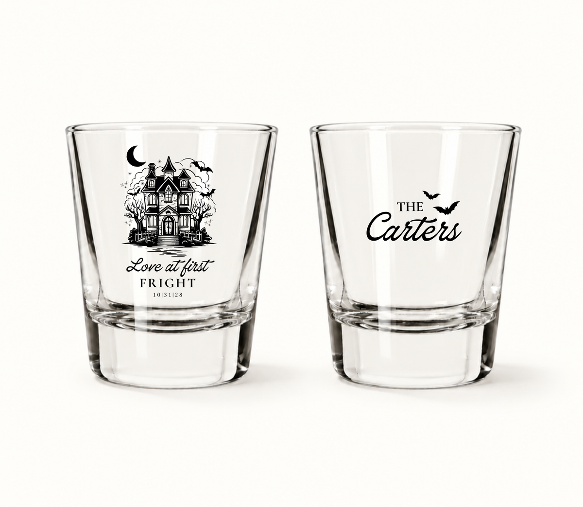 Personalized clear Love at First Fright Halloween wedding shot glasses featuring a black haunted house, bats, Carter surname, and wedding date 10.31.28.