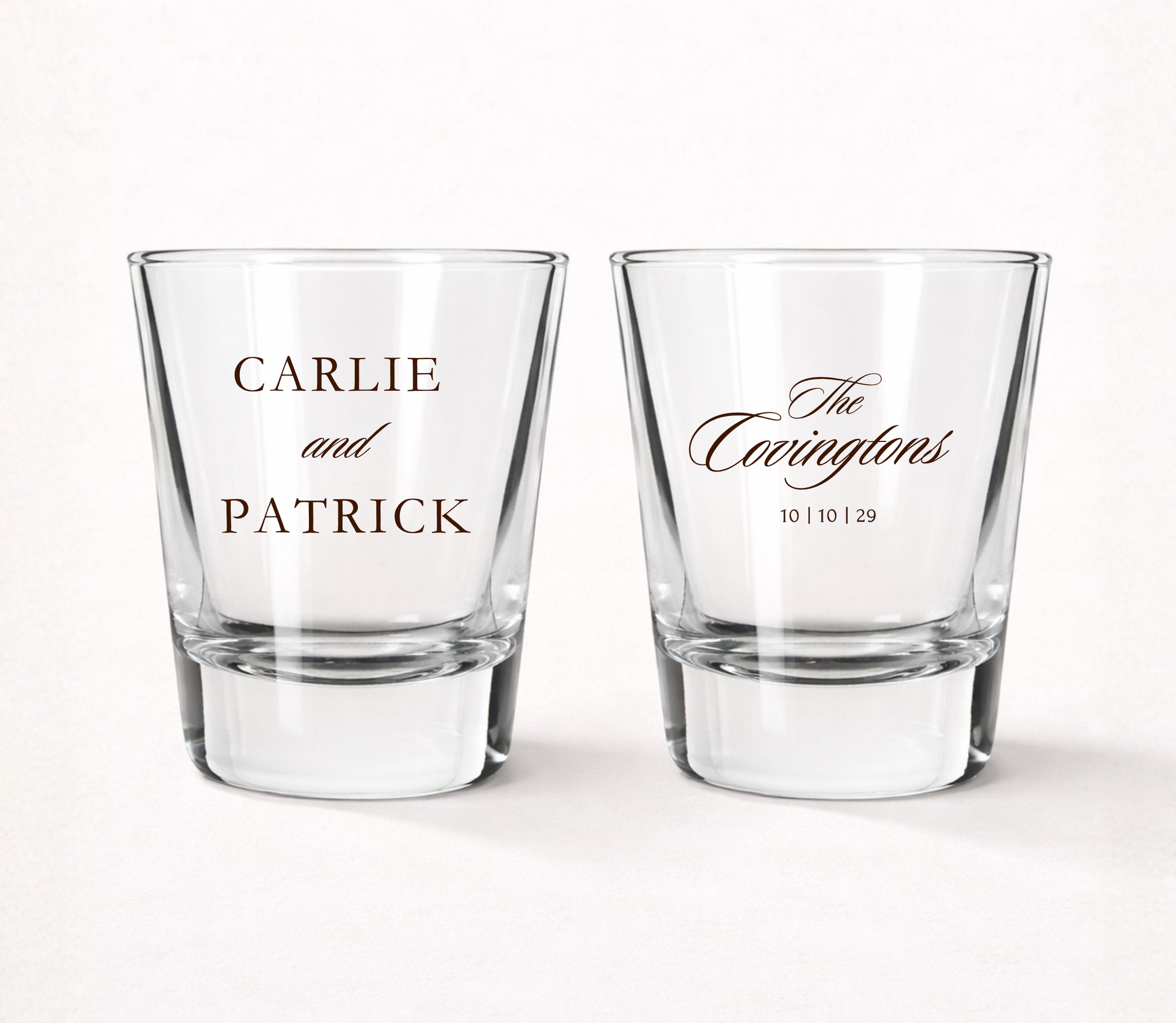 Clear personalized classic wedding shot glasses featuring elegant couple names, family surname, and wedding date.