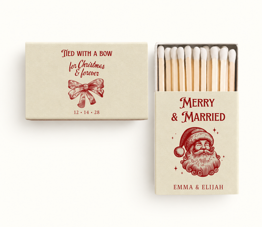 Personalized cream Christmas wedding matchboxes featuring red vintage Santa artwork, holiday bow illustration, couple names, and wedding date.