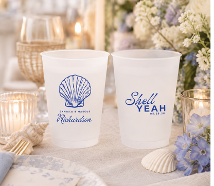 Custom coastal wedding frosted cups with blue seashell artwork, personalized names, wedding date, and beach inspired wording