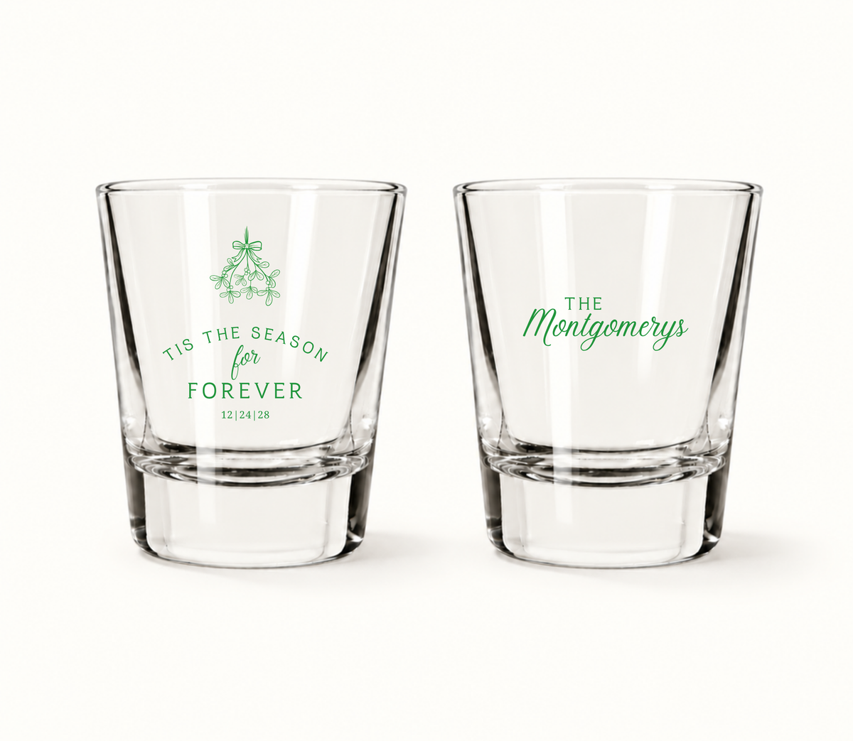 Personalized Tis The Season For Forever Christmas wedding shot glasses featuring mistletoe artwork, custom family name, and wedding date.
