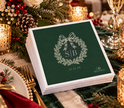 Green Christmas wedding napkin featuring a botanical wreath, personalized initials, and wedding date.