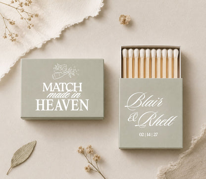 Custom Match Made in Heaven wedding matchboxes featuring romantic typography, cupid artwork, and safety matches.