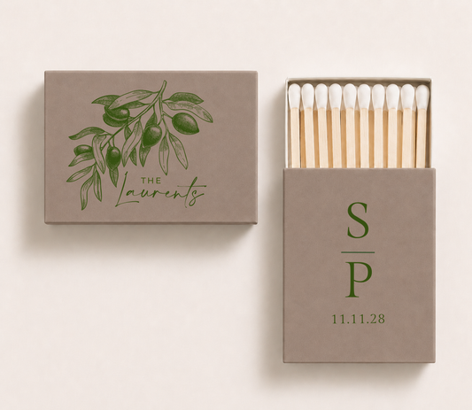 Taupe personalized olive wedding matchboxes featuring olive branch artwork, custom family name The Laurents, couple initials S and P, and wedding date.

Taupe olive wedding matchbox featuring botanical olive branch illustration and personalized family name.

Personalized Italian wedding matchbox featuring elegant olive branch design and custom details.