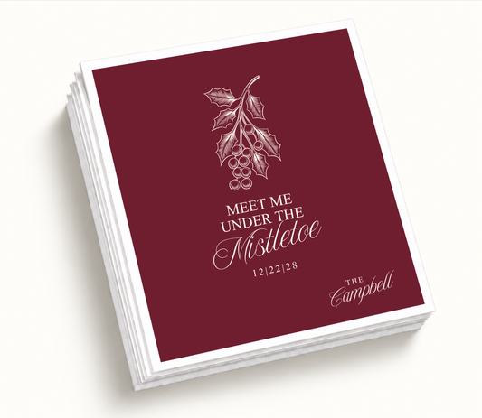 Personalized Mistletoe Christmas Wedding Napkins featuring a burgundy background with elegant mistletoe illustration, family surname, couple names, and wedding date.