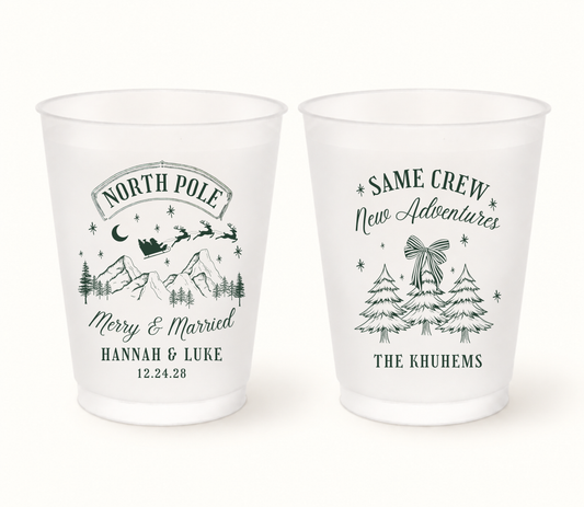 Personalized North Pole Christmas wedding frosted cups featuring snowy mountain, pine tree, and holiday winter illustrations with custom names and date.