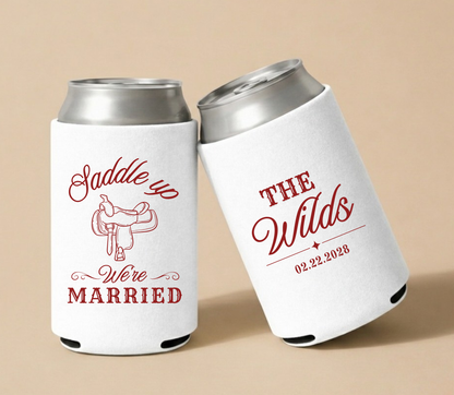Custom Saddle Up western wedding can coolers with red saddle artwork, personalized couple name, and wedding date on white drink sleeves  