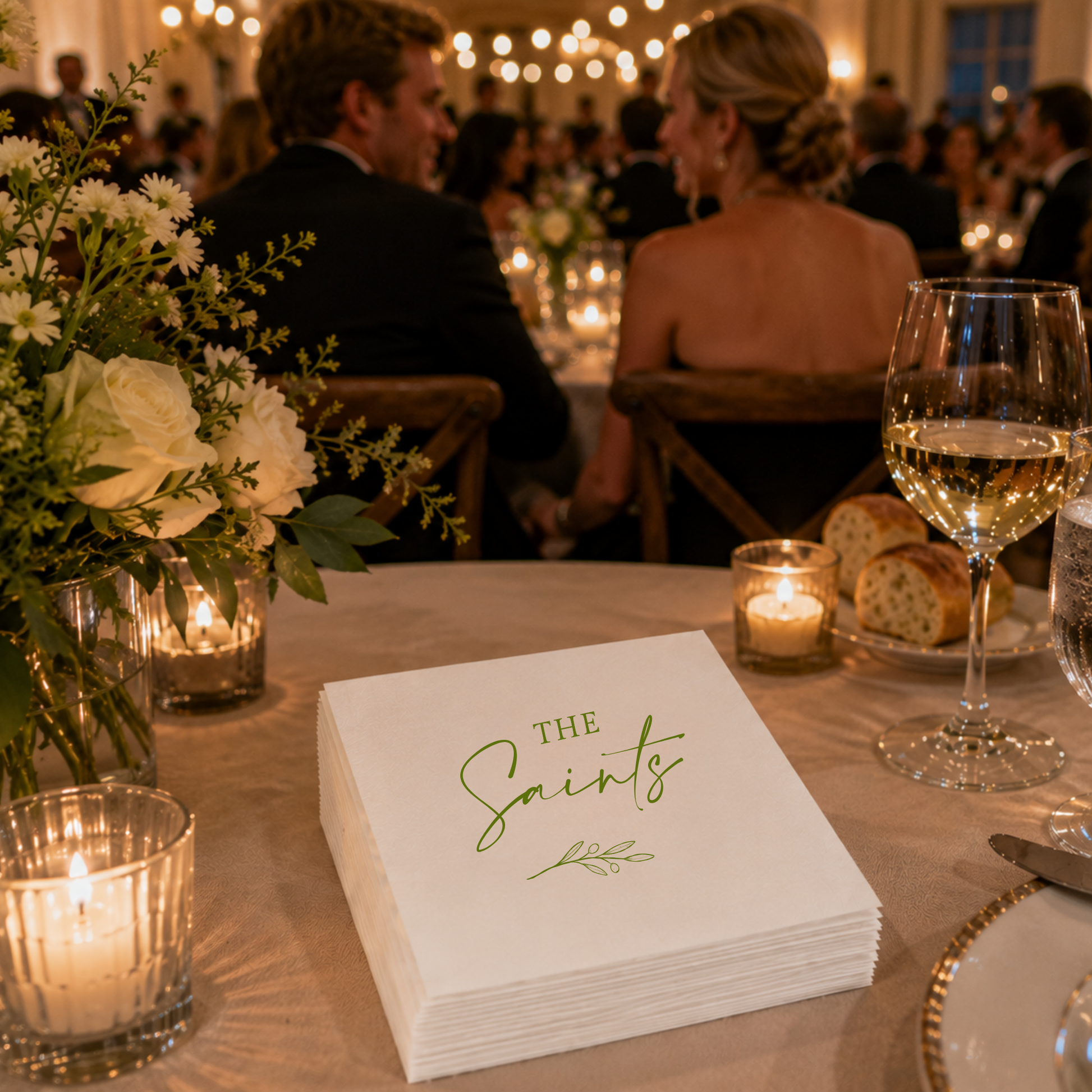 
White personalized wedding napkin featuring custom family name and olive branch artwork.

