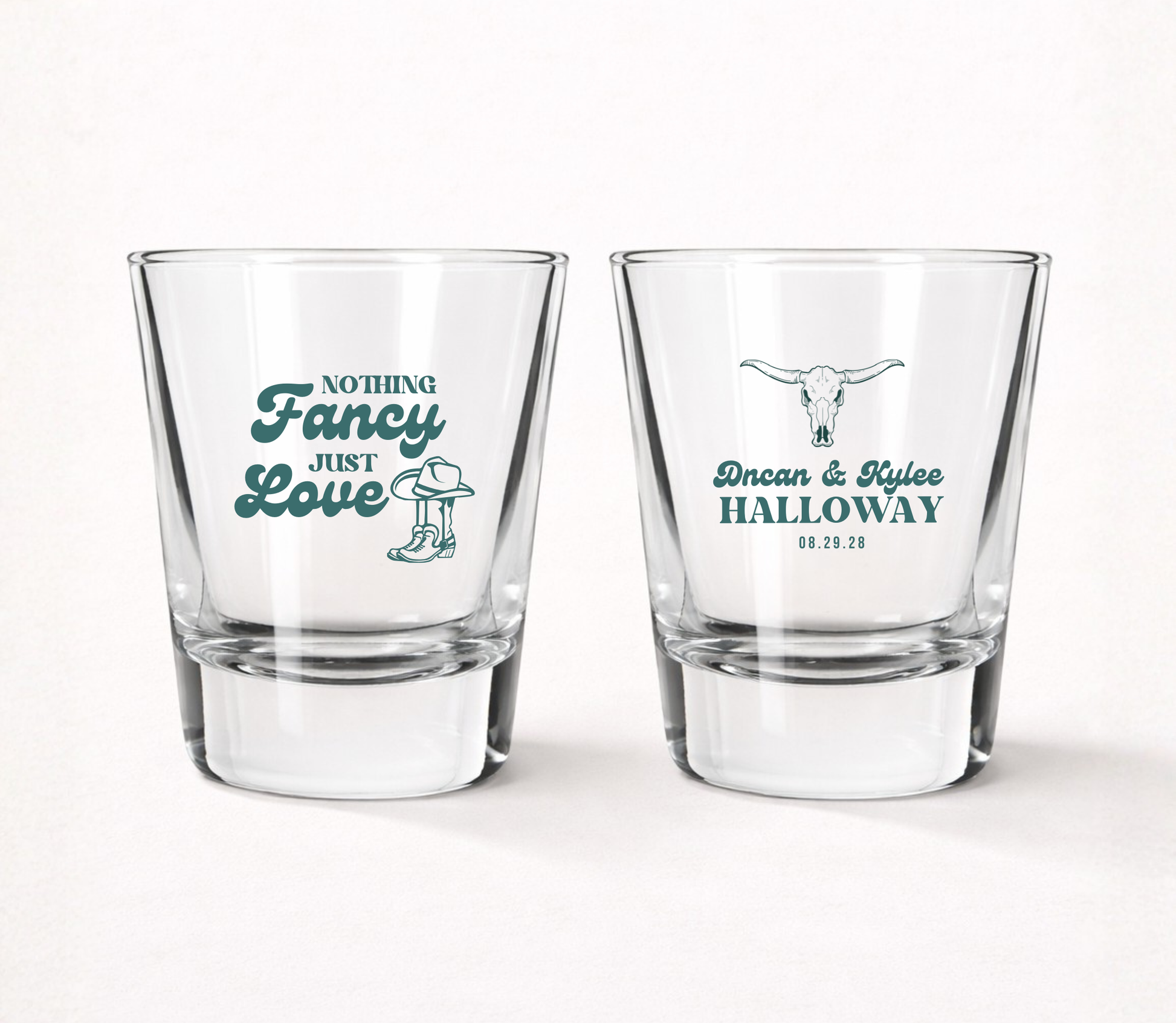 Clear personalized wedding shot glasses featuring cowboy boots, cowboy hat, longhorn skull artwork, custom couple names, family surname, and wedding date.