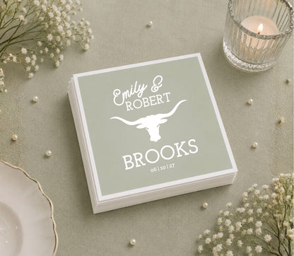 Custom cowboy wedding table napkin featuring longhorn artwork, personalized names, and wedding date.