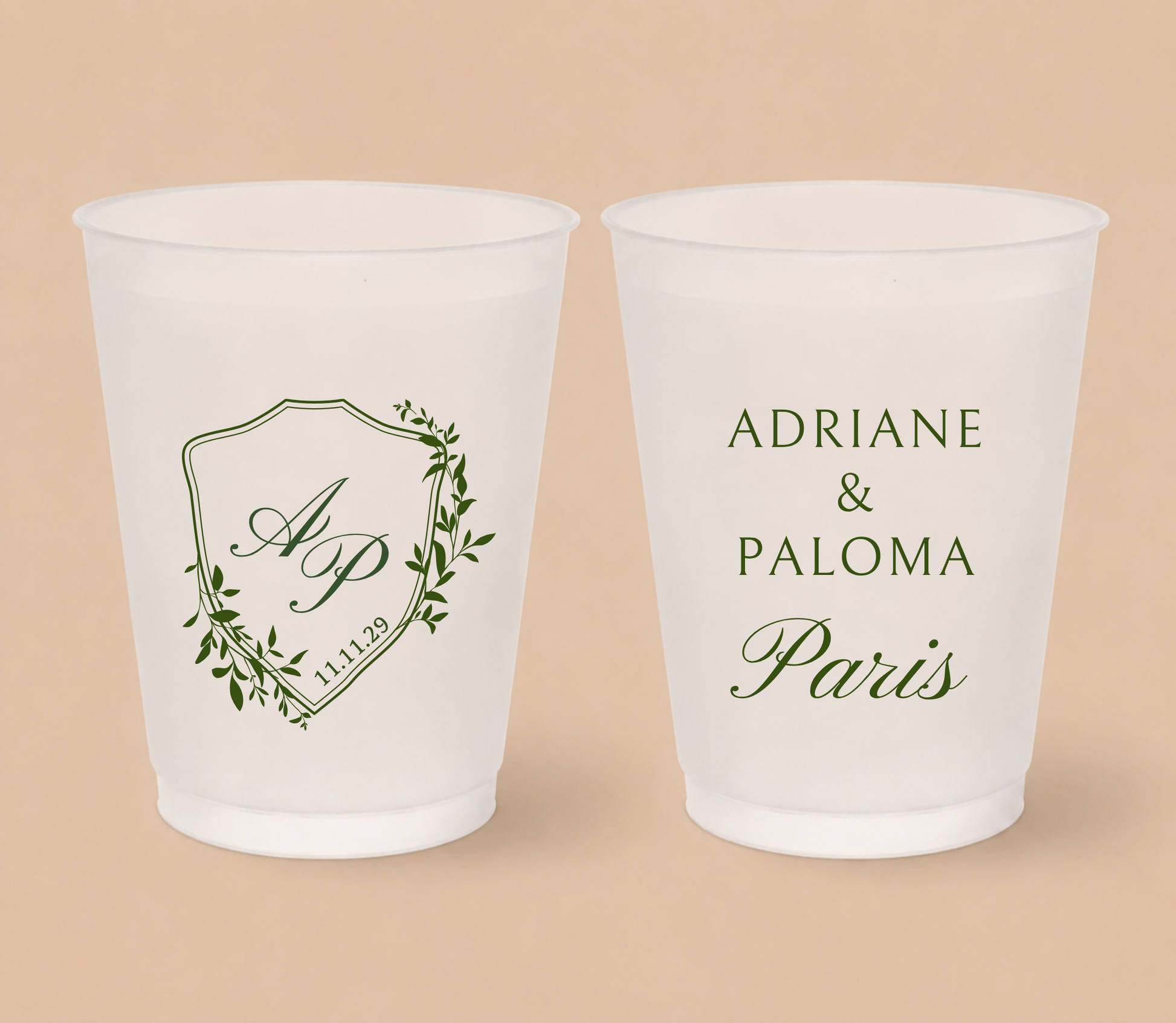 White frosted wedding cups featuring a botanical crest with custom initials AP, wedding date, and personalized names Adriane and Paloma Paris.