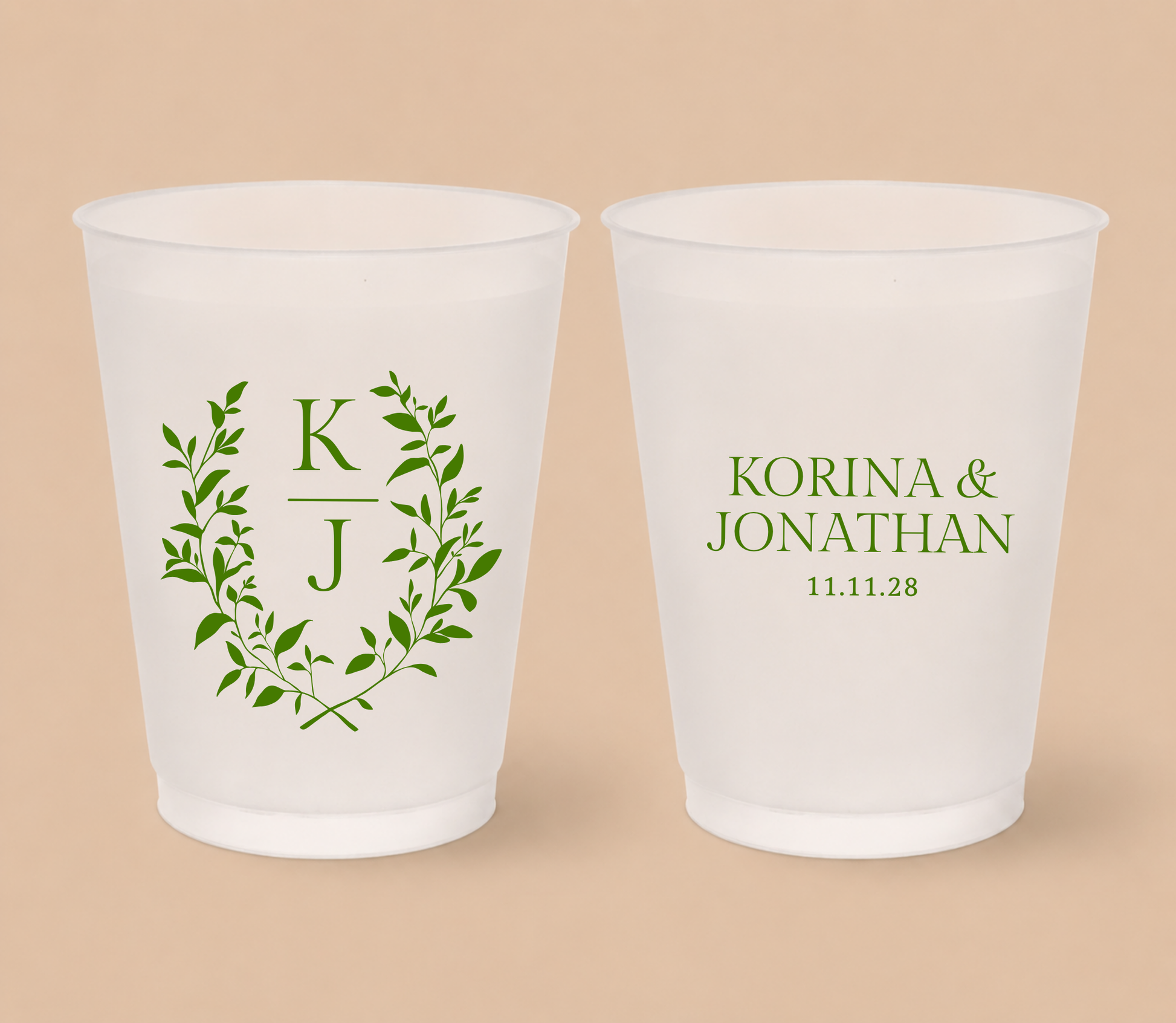 White frosted wedding cups featuring a botanical leafy wreath with custom initials K and J, personalized names Korina and Jonathan, and wedding date.