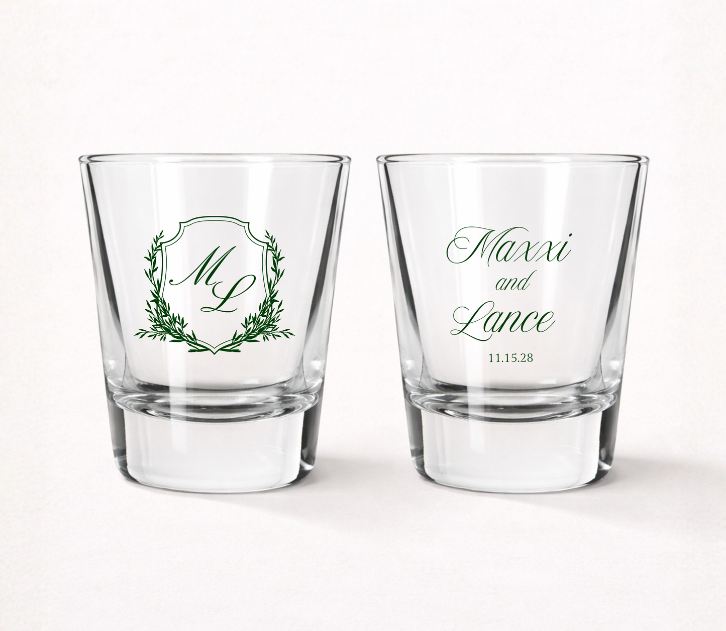 Personalized Maxxi Laurel Monogram wedding shot glasses featuring custom initials, couple names, wedding date, and elegant laurel frame.