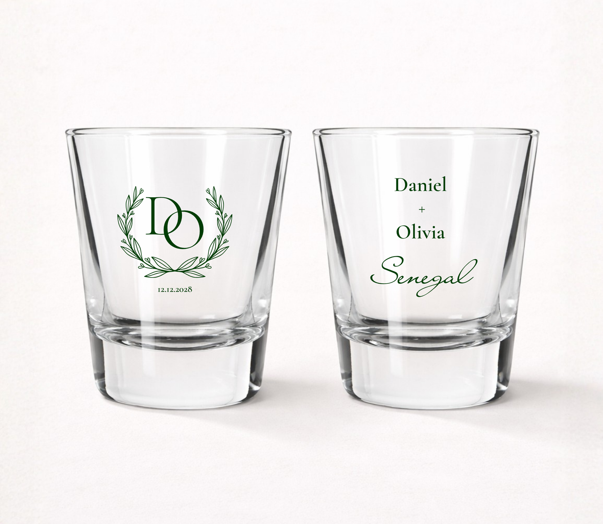 Personalized Classic Laurel Monogram wedding shot glasses featuring custom initials inside a laurel wreath with couple names, family name, and wedding date.
