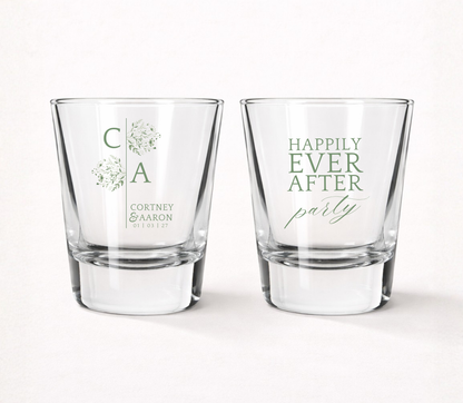 Clear personalized minimalist wedding shot glasses featuring floral initials, custom couple names, Happily Ever After Party design, and wedding date.
