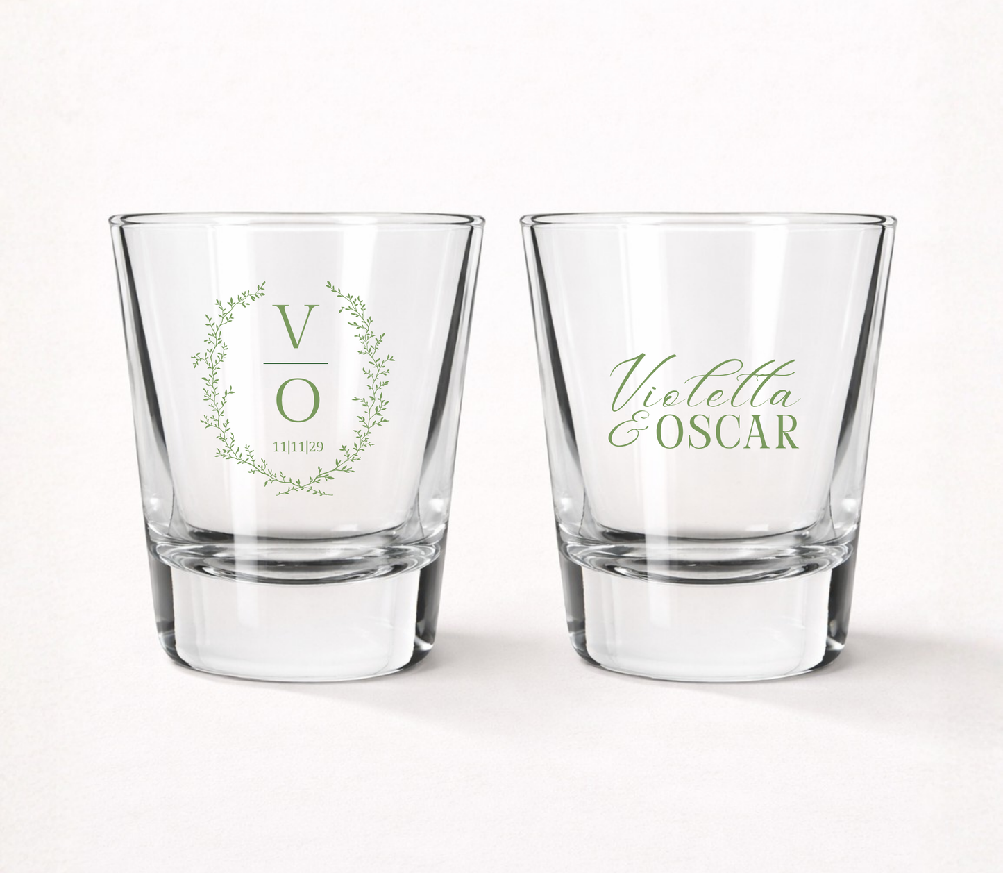Personalized Botanical Monogram wedding shot glasses featuring a custom initial, delicate greenery wreath, couple 