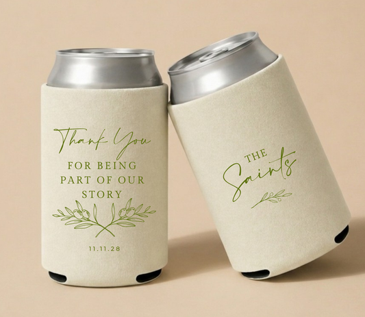 Cream personalized wedding can coolers featuring botanical olive branch artwork, heartfelt thank you message, custom family name The Saints, and wedding date.
