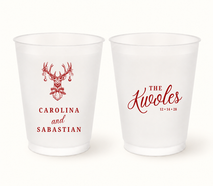 Personalized Christmas reindeer wedding frosted cups featuring holiday deer illustration, custom couple names, surname, and wedding date.