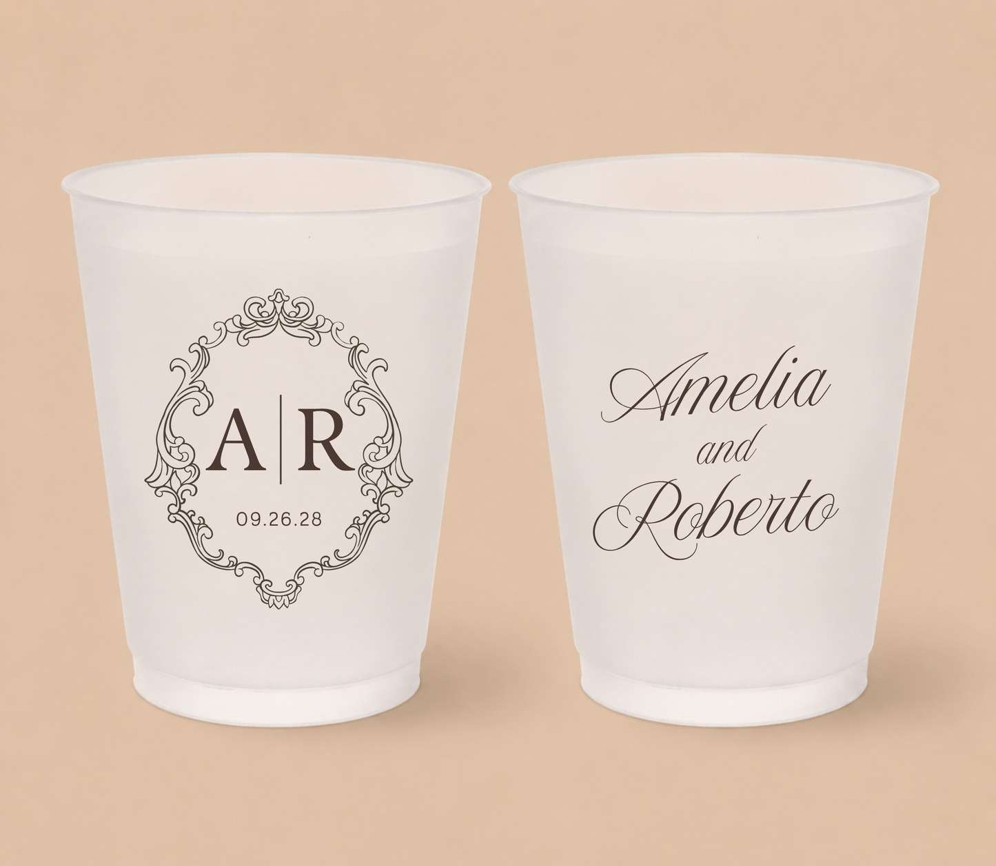 White frosted wedding cups featuring an ornate vintage monogram with custom initials AR, couple names Amelia and Roberto, and wedding date.
