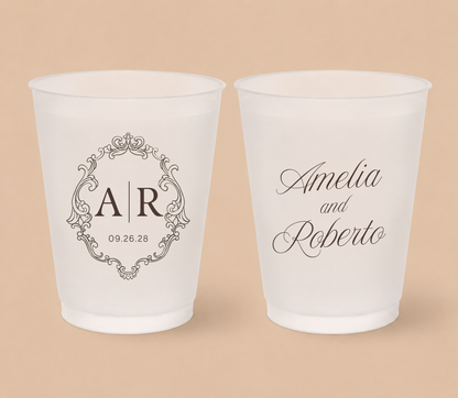 White frosted wedding cups featuring an ornate vintage monogram with custom initials AR, couple names Amelia and Roberto, and wedding date.
