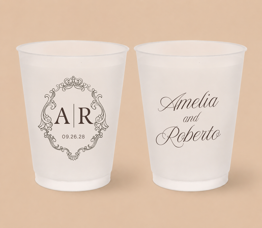 White frosted wedding cups featuring an ornate vintage monogram with custom initials AR, couple names Amelia and Roberto, and wedding date.
