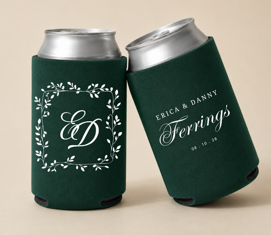 Dark green personalized wedding can coolers featuring a botanical monogram frame with custom initials, the family name Ferrings, couple names Erica and Danny, and wedding date.
