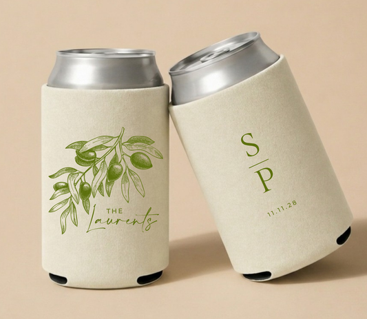Cream personalized wedding can coolers featuring a vintage olive branch illustration, custom family name Laurents, monogram initials S and P, and wedding date.
