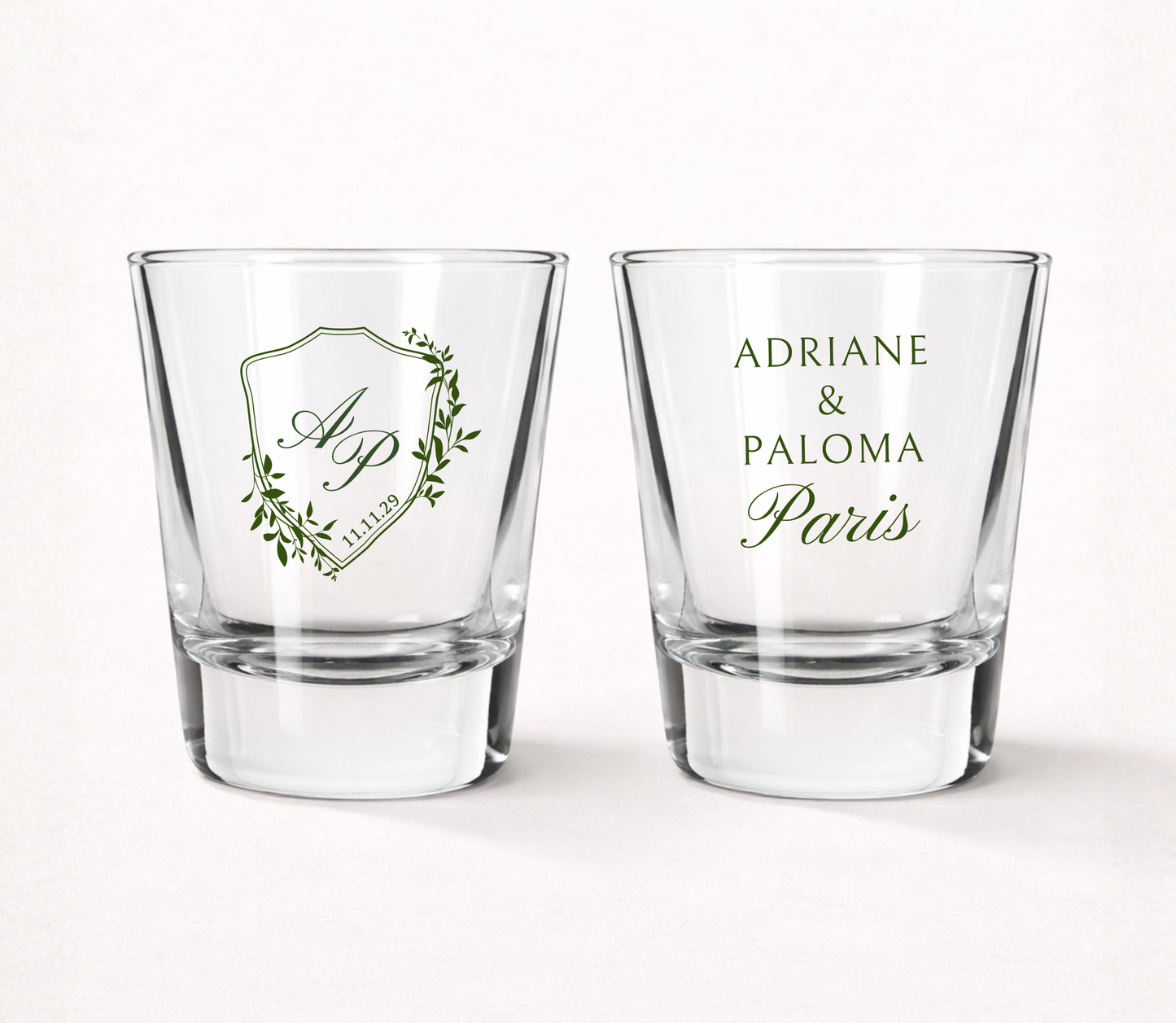 Personalized Paris Crest wedding shot glasses featuring custom initials, couple names, wedding date, and an elegant botanical crest design.