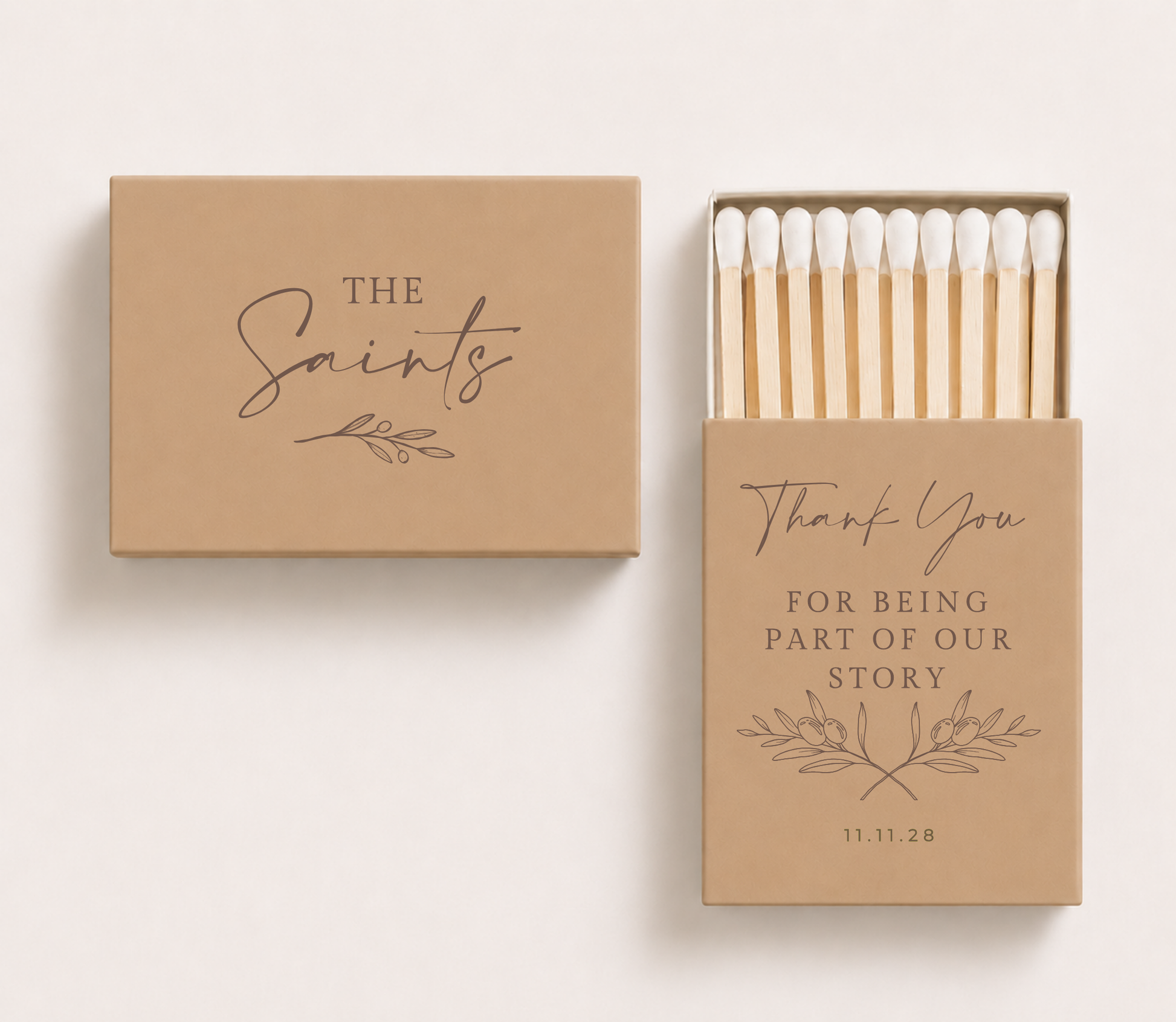 Beige personalized wedding matchboxes featuring The Saints family name on the outer box and a thank you message with olive branch artwork and wedding date on the inner sleeve.

Personalized thank you wedding matchbox featuring custom family name and olive branch design.

Personalized thank you wedding matchbox featuring custom family name and olive branch design.